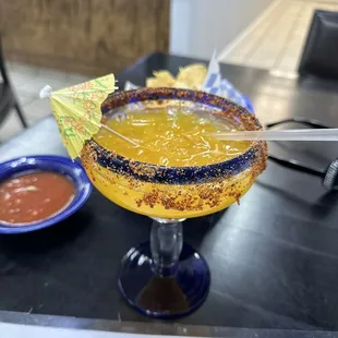 a margarita with a garnish on the rim