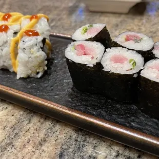 a plate of sushi and a pickle