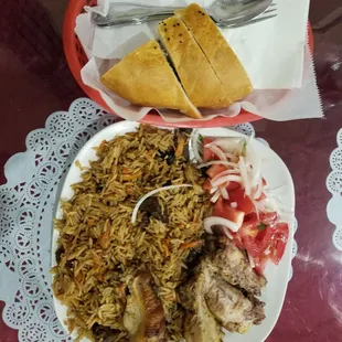 Plov - brown rice with carrots and small cut meats served with fresh salad. You can have it with kabob or chicken. And the best bread