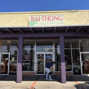 a woman walking out of a building