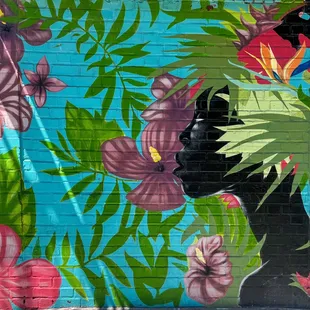 a mural of a woman with flowers
