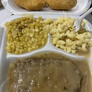 Meatloaf in brown gravy, fried corn, macaroni and cheese, and hushpuppies