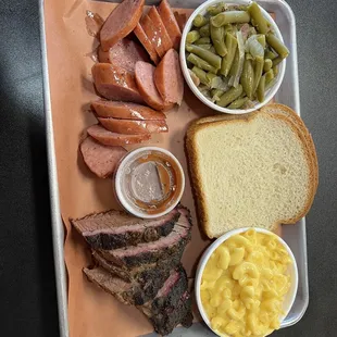 a tray of meat, macaroni, and cheese