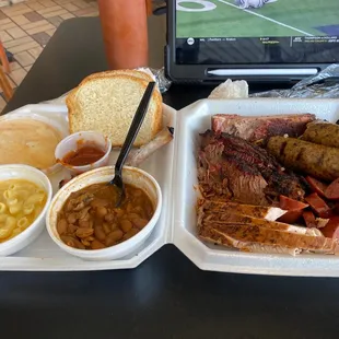 a tray of meat, beans, macaroni, and cheese