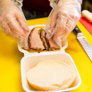 a person preparing a sandwich