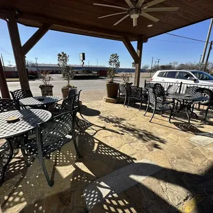 a patio with tables and chairs