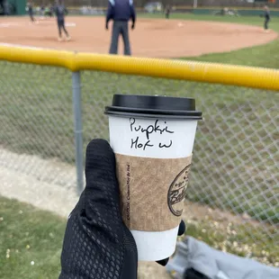 a cup of coffee in hand