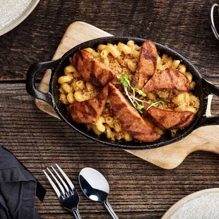 Cajun Mac and Cheese includes cavatappi noodles, spicy cheese sauce, grilled andouille sausage and tomato concasse