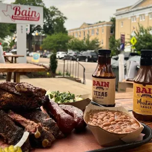 BBQ platter with brisket, chicken, jalapeño cheddar sausage, ribs, and sides: mac &amp; cheese, baked beans, and jalapeño cole slaw