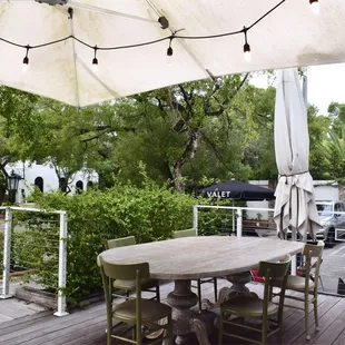 a patio with a table and chairs