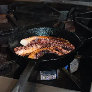 a pan of food cooking on a stove