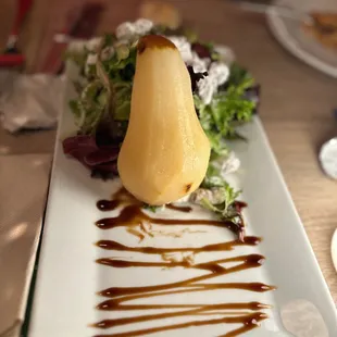 a plate of food with a pear on it