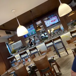 a woman sitting at a table in a restaurant