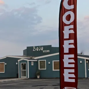 a coffee shop with a red and white flag