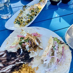 plates of mexican food on a blue table