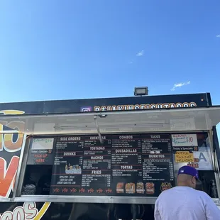 a man standing in front of a food truck