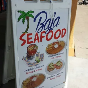 Signboard out front on the sidewalk.