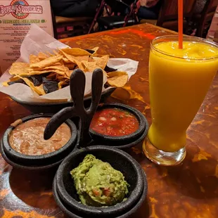 Complimentary chips and salsa and frozen mango margarita mocktail