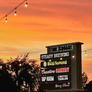 a neon sign at sunset