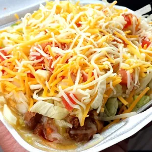 Small frito pie w/ green chili sauce, ground beef, refried beans, onions, lettuce, tomato, cheese. Can also get red chili sauce.