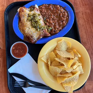 a plate of beans, tortilla, and chips