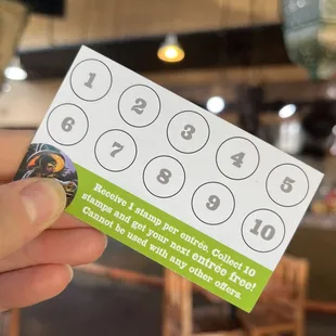 a hand holding a business card