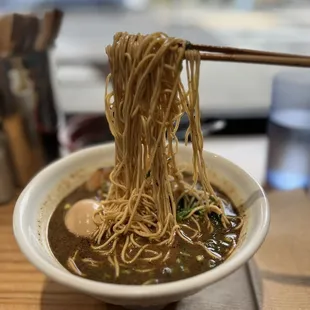 a bowl of ramen with chopsticks