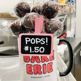 a mug of chocolate covered donuts