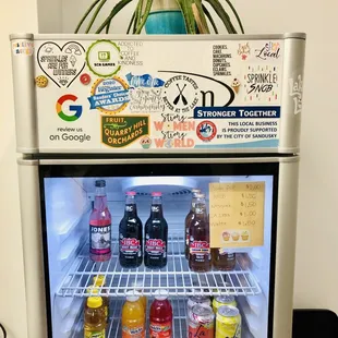 a refrigerator with various drinks and condiments