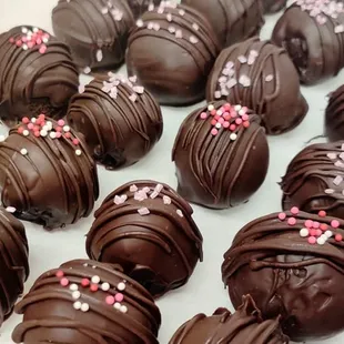 a tray of chocolate truffles with sprinkles