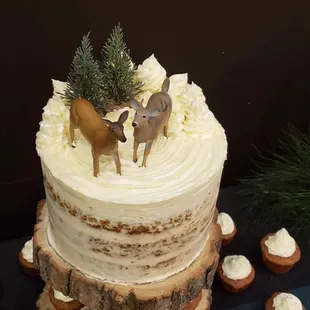 a cake with frosting and deer decorations