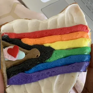 a person holding a heart shaped cookie