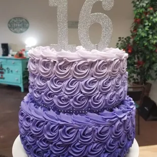 a purple and white cake with the number sixteen on top