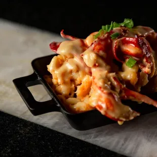 Lobster Mac
 
 Mac topped with lobster cooked in garlic butter &amp; cheese sauce.