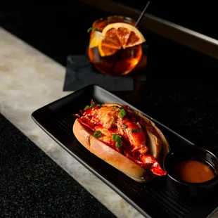 Lobster Roll
 
 Lobster tossed in a garlic butter sauce served on a bun with a side of old bay fries.