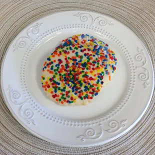 a white plate with sprinkles on it