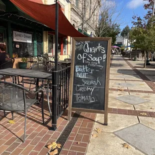 a chalkboard sign on a sidewalk