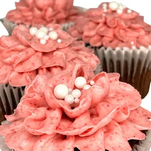 three cupcakes with pink frosting
