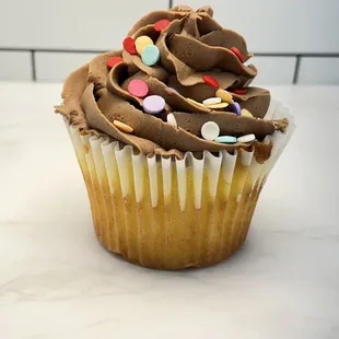 a cupcake with chocolate frosting and sprinkles