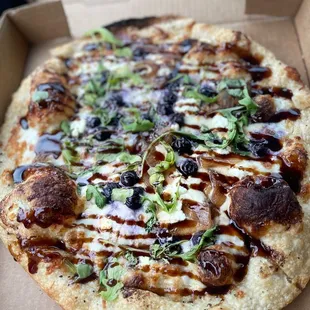 a pizza in a cardboard box