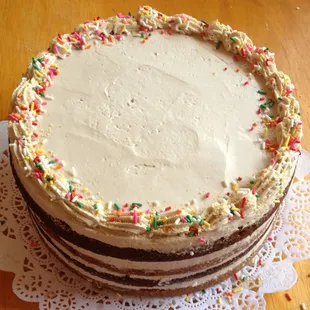 Fall Favorite cake. layers of pumpkin spice cake, carrot cake all held together with maple buttercream. Fall flavors.