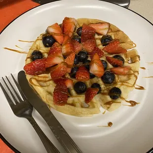 a waffle with strawberries and blueberries