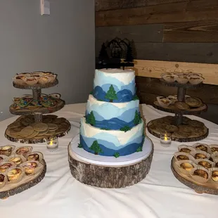 a table with a cake and pastries