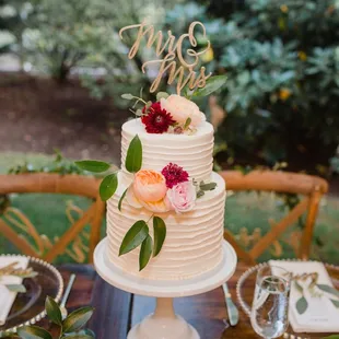 a wedding cake with flowers on top