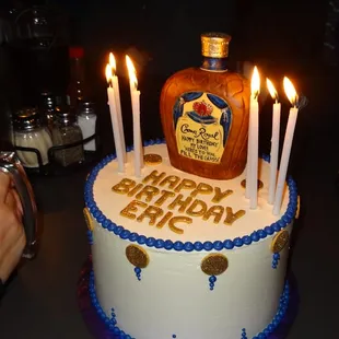 8&quot; round, red velvet with cream cheese filling, and rice crispy Crown Royal bottle.