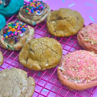 a variety of cookies on a cooling rack