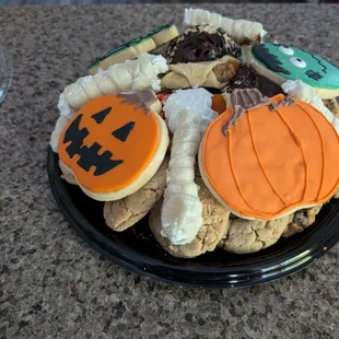 a lot of cookies piled onto a small tray