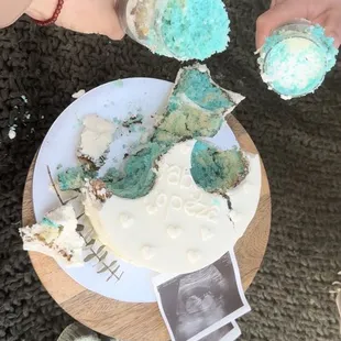 two hands reaching for a piece of cake