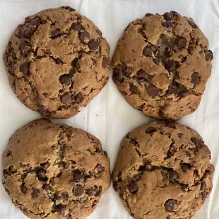 four chocolate chip cookies on a napkin