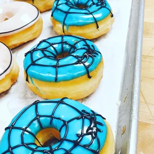 blue frosted donuts with spider webs